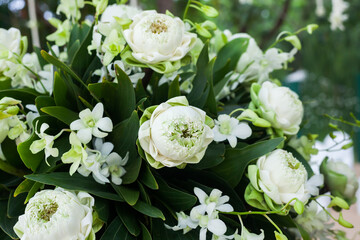 Floral arrangement at a wedding ceremony on beach.