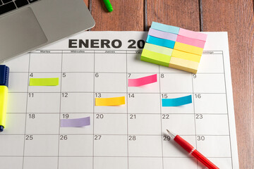 Calendar of the month and several colored adhesive notes to highlight the activities to be done....