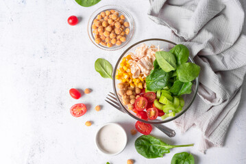 Salad bowl with chicken and protein. Healthy vegetable  buddha bowl with healthy greens. Fitness and weight loss food tomato, spinach and chickpeas salad. 