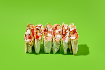 Shawarma with vegetables and meat on green background. Contemporary poster with shawarma. Doner...