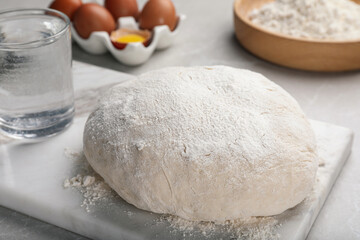 Fototapeta na wymiar Dough on white marble board, closeup. Sodawater bread recipe
