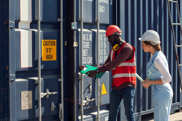 Businesswoman and engineer talking and checking loading Containers box from Cargo freight ship for import export. shipping in docks.