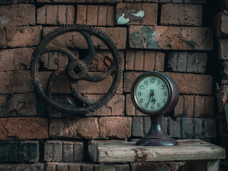 Fototapeta na wymiar brick wall with big vintage gear and clock abstract grunge background