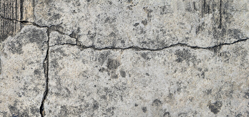 Cracked concrete texture closeup background.