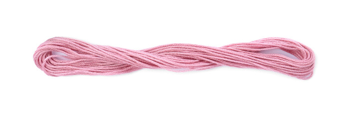 Pale pink embroidery thread on white background, top view