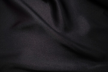 Abstract Black, Black Satin Silky Cloth Fabric Textile Drape with Crease Wavy Folds background....