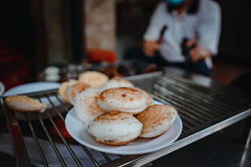 Sizzling Vietnamese mini egg - Vietnamese cuisine, Banh Can. Vendor hawker making Banh Can