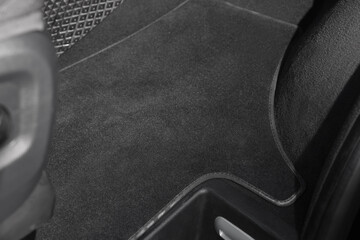 Grey soft floor carpet in car, closeup