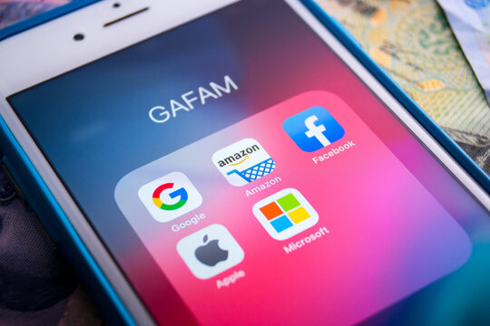 Kumamoto, Japan - May 29 2020 : GAFAM apps on iPhone on money..Google, Amazon, Facebook, Apple & Microsoft are 5 US multinational IT or online service companies that dominated cyberspace during 2010s