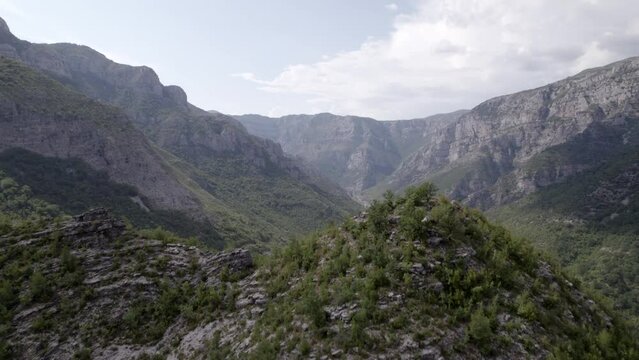 Drone video of frontal discovery plane over a peak of the "Rrapsh Serpentine" mountain pass on the Sh20 road in Grabom, Albania,
Leqet e Hotit