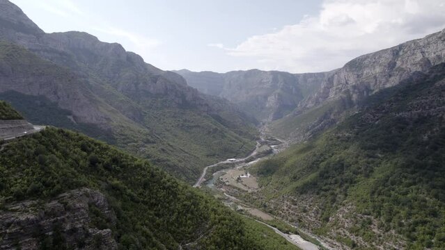 Drone video of side shot "slider" discovery over a peak of the "Rrapsh Serpentine" mountain pass on the Sh20 road in Grabom in Albania,
Leqet e Hotit