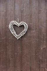 A heart as a decoration on a brown wooden wall 