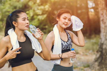 healthy sport women thirsty drinking water during exercise in hot summer season