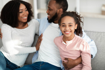 Portrait of happy black family spending time together at home