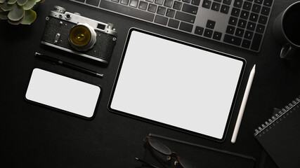 Digital devices on black table background. Tablet and smartphone mockup