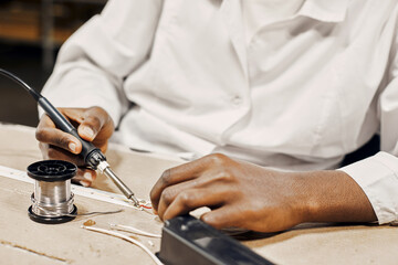 Man soldering led lamps with tools