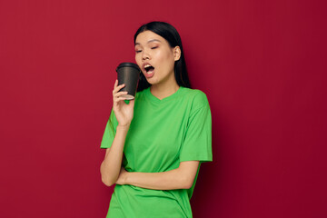 woman smile green t-shirt black disposable cups fashion studio model unaltered