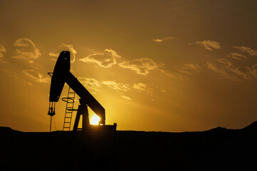 oil drilling in sunset - bahrain