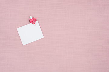 blank sheet of paper on a pink background, concept Valentine's Day