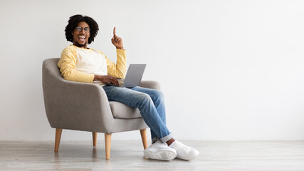 Inspiration Concept. Funny Black Excited Guy With Laptop Pointing Finger Up