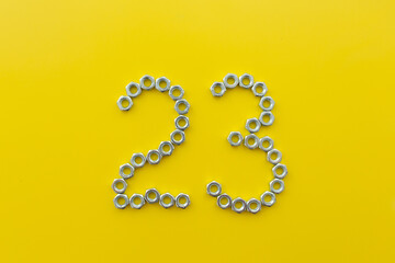 The number 23 of nuts on a yellow background. Defender of the Fatherland Day