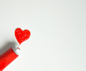 A red heart made of toothpaste. Toothpaste in a shape of a heart on light background. 