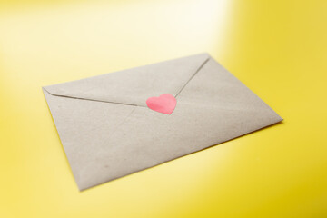 Love letter with red hearts. Yellow background top view mockup
