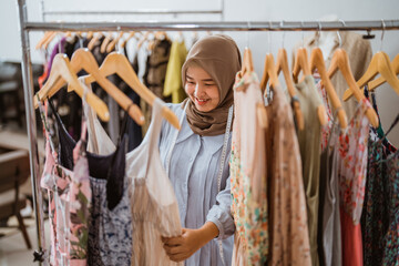 Fototapeta na wymiar muslim fashion designer checking her dress product