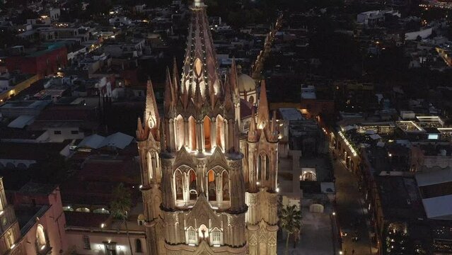 Aerial: amazing view of the cathedral church in San Miguel de Allende at night in Guanajuato. Drone view