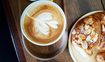 Hot Cappuccino In Cup On Wooden Table With Copy-space. The Latte Art On coffee background.