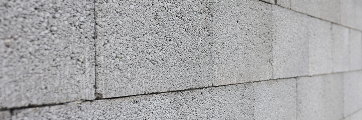 Gray concrete wall made of rectangular blocks