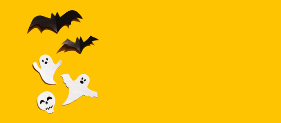 Halloween set decorations with ghost, bat and skeleton on yellow background. Holiday party, minimal...