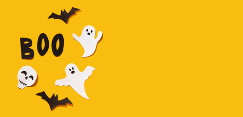 Halloween set decorations with ghost, bat, skeleton and word BOO on yellow background. Holiday party, minimal greeting card, spooky concept. flat lay, copy space, top view, place for text