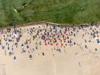People bathing in the sun, swiming and playing games on the beach. Tourists on the sand beach of Zatoka, Ukraine