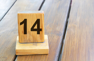 Wooden priority number 14 on a plank tab