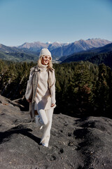 Naklejka premium woman standing on the top of the mountain forest relaxation