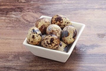 Raw quail eggs heap in the bowl