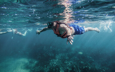 Snorkeling above algae and corals
