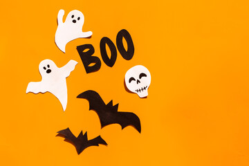 Halloween set decorations with ghost, bat, skeleton and word BOO on orange background. Holiday party, minimal greeting card, spooky concept. flat lay, copy space, top view, place for text