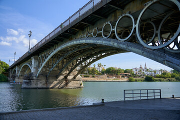 View of the Triana bridge in Seville with the Guadalquivir river, from the Paseo of la O.