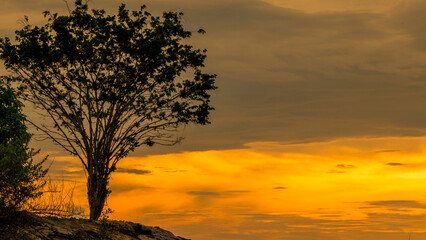 Obraz premium The background of the sea by the evening sea, with natural beauty (sea water, rocks, sky) and fishermen are fishing by the river bank, is a pleasure during travel.