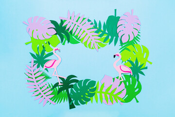 Fototapeta na wymiar Colorful leaves of monstera, palms and flamingos on a blue background.