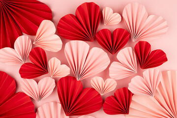 Elegant Valentine day background with mix of many sweet pink and red origami paper hearts on soft...