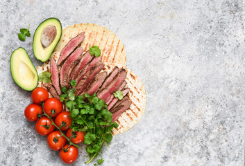 Ingredients for tacos: beef, vegetables, cilantro.