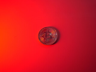 Bitcoin cryptocurrency money. Btc investment coin. Gold bitcoin coin on red background. Trading payment currency. Bitcoin business mining