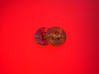 Two bitcoin coins on red background. Digital crypto coin. Bitcoin business money. Coinbase trading. Cryptocurrency exchange. Bitcoin mining. Two gold coin on red background 