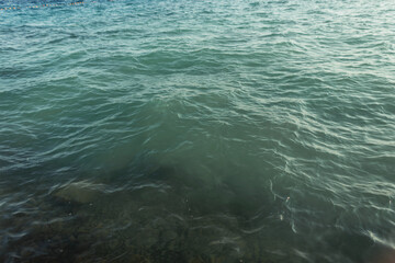 Beautiful green water with waves and ripples. Summer vacation by the sea. Sea and watercolor background