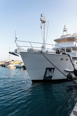 Naklejka premium White beautiful expensive yacht is on the pier. Travel by ship. Summer vacation at sea
