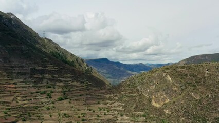 Aerial view of the nature of the Andes mountains in Peru. Mountain slopes are covered with forests, rocky mountain ranges and heights with peaks.