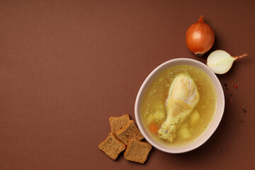 Concept of tasty food with chicken soup on brown background
